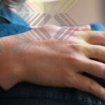 Person with their hand around someone's shoulders